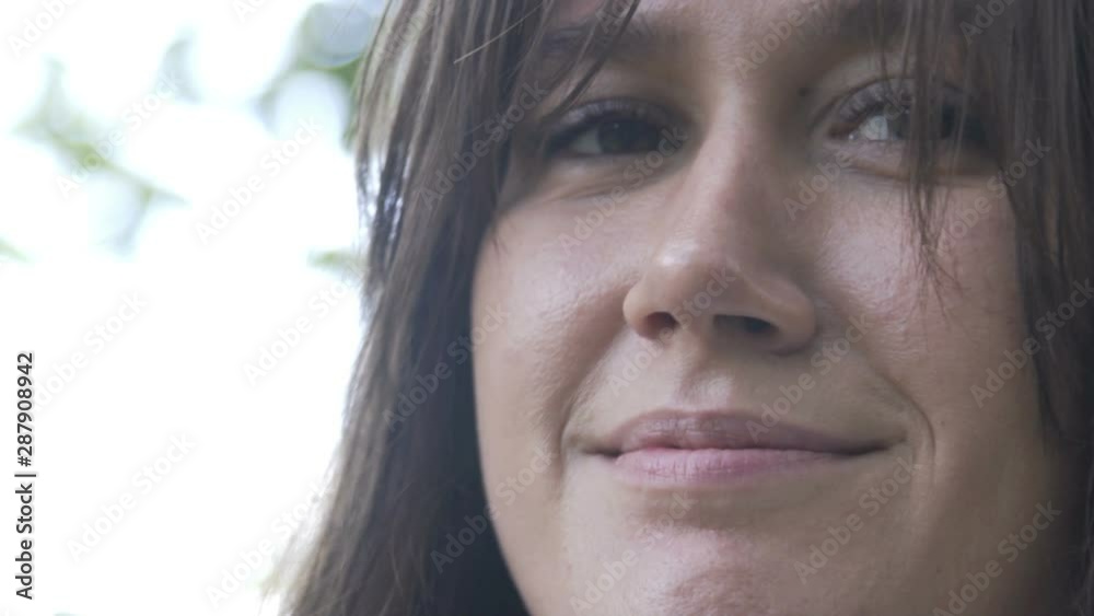 Portrait of Young brunette woman portrait smiling happy successful in park or forest. Extreme close up shot Portrait of Young brunette woman portrait smiling happy successful in park or forest. Extreme close up shot