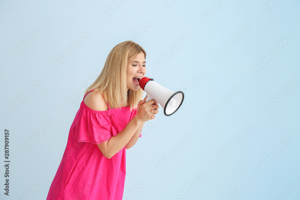 Screaming woman with megaphone on color background Screaming woman with megaphone on color background