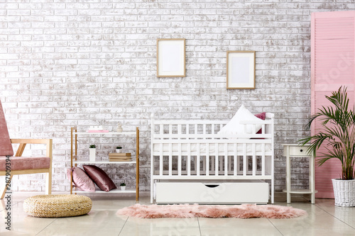 Interior of stylish children's room with baby bed