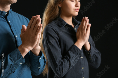 Religious couple praying to...
