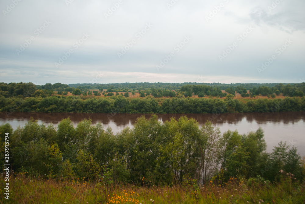 Brown river and dramatic background. The water in the river became dirty after heavy rains, Brown river and dramatic background. The water in the river became dirty after heavy rains,
