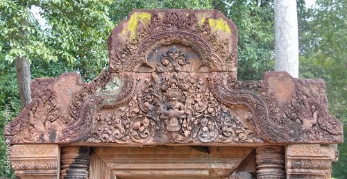 Carved pediment over doorway at Banteay Srei temple is a story of Narasimha (Vishnu god as lion) claws Hiranyakasipu (king of demon) is sacred places and famous tourist attraction in Cambodia. photo