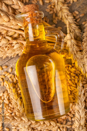 Homemade organically produced wheat oil on a rustic wooden table
