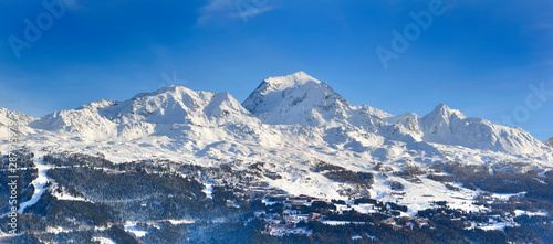 view on peak mountain covered with snow in winter above ski resort in european alps © coco