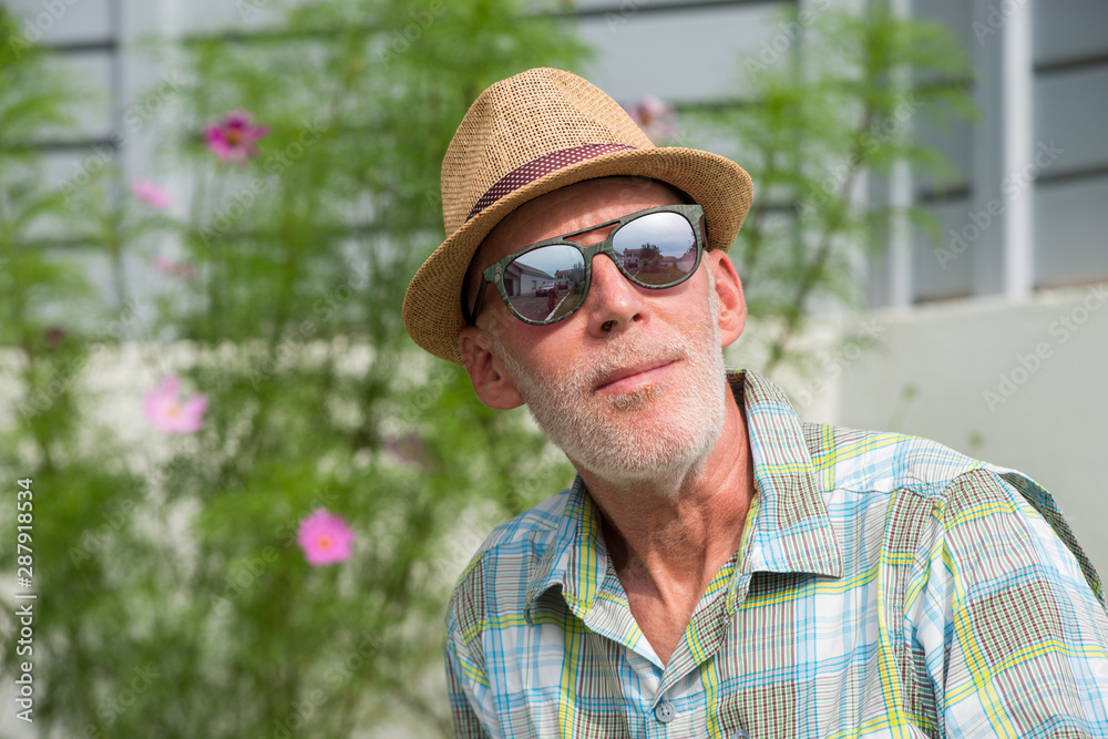 senior man in summer cap and sunglasses portrait