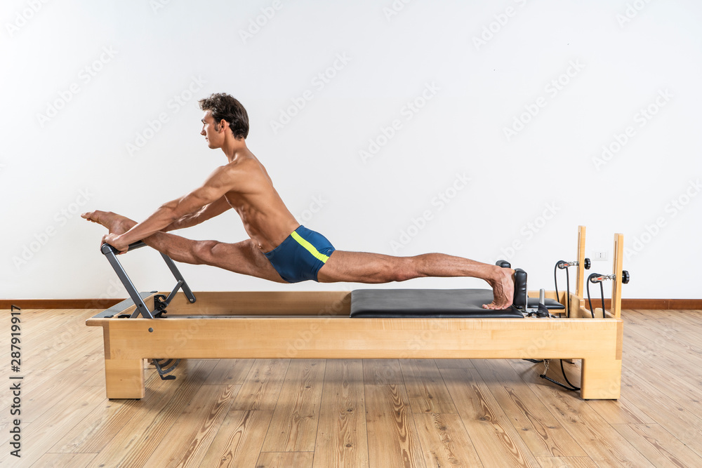 Pilates exercise on the reformer machine Pilates exercise on the reformer machine