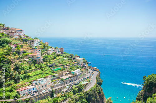 Beautiful cozy bay with boats and clear turquoise water in Italy
