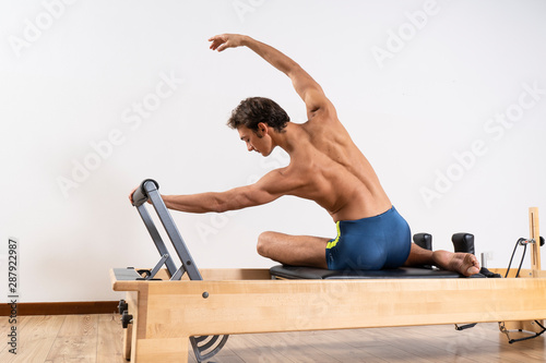 Pilates exercise on the reformer machine photo