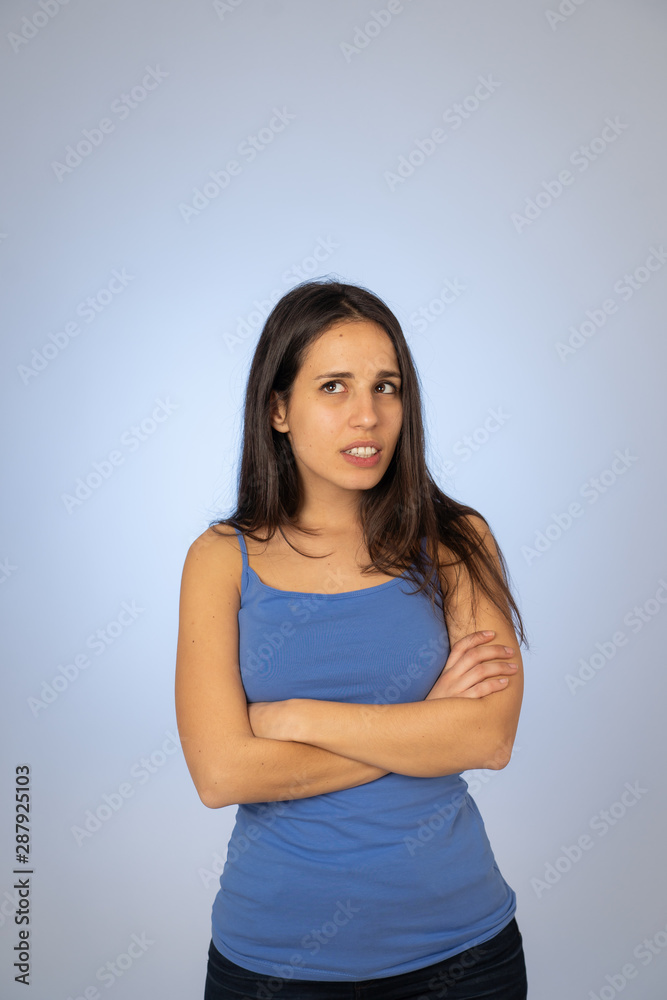 Portrait of unsatisfied latin teenager young woman looking worried with concern face Portrait of unsatisfied latin teenager young woman looking worried with concern face