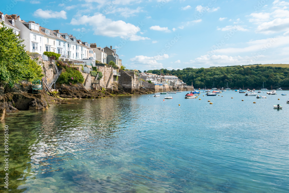 Boats moored in Fowey Estuary at beautiful Cornish harbour town Fowey in South Cornwall, England