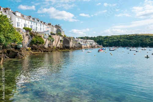 Boats moored in Fowey Estuary at beautiful Cornish harbour town Fowey in South Cornwall, England photo