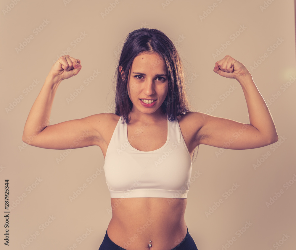 Portrait of sporty beautiful brunette woman in sport clothes looking sensual and fit Portrait of sporty beautiful brunette woman in sport clothes looking sensual and fit