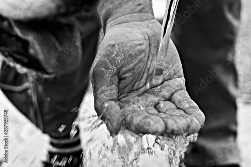Closeup of man hand catching water/ Hands catching clean falling water © Sanja