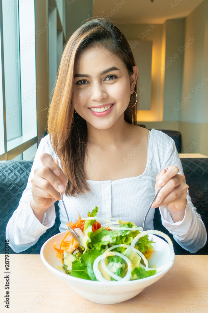Beautiful healthy woman is holding vegetables salad Beautiful healthy woman is holding vegetables salad