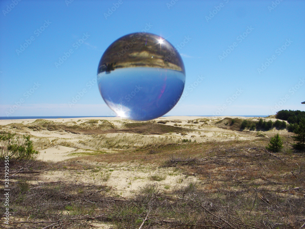 Glass ball on the background of the dune of Efa Glass ball on the background of the dune of Efa
