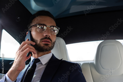 Handsome bearded man wearing suit calling secretary © zinkevych
