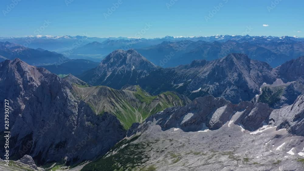 Aerial view of summit of Zugspitze mountain, highest peak of Germany and Wetterstein Mountains during summer - landscape panorama of Alps from above, Germany/Austria border, Europe Aerial view of summit of Zugspitze mountain, highest peak of Germany and Wetterstein Mountains during summer - landscape panorama of Alps from above, Germany/Austria border, Europe