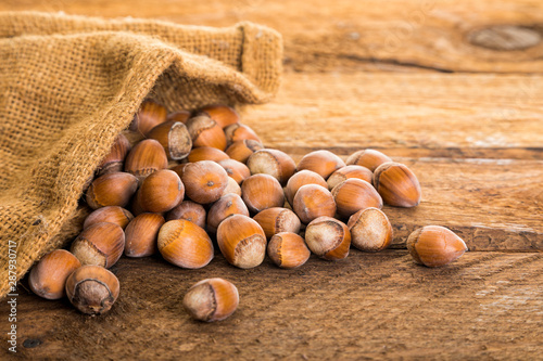 hazelnuts in burlap bag on rustic table