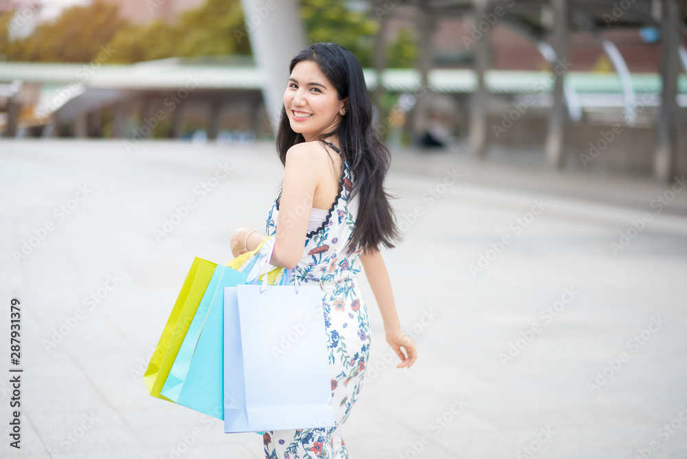 Beautiful woman is happy with shopping in city