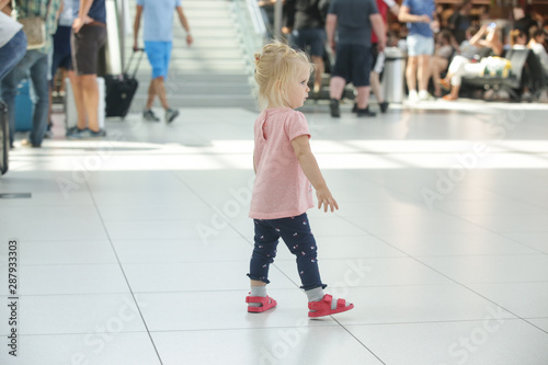 Child lost at the airport or shopping mall, little girl looking for her parents