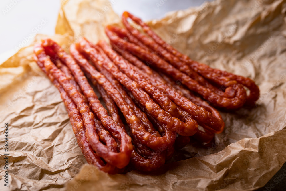 Thin dried pork sausages. Meat tasty snack