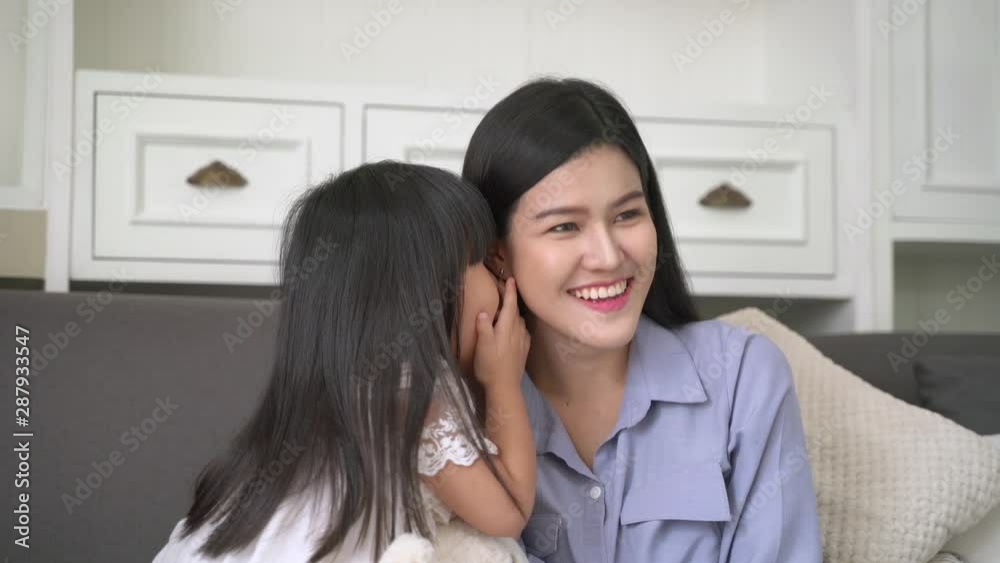 Happy mother and cute child daughter is whispering to talk to her mother Happy mother and cute child daughter is whispering to talk to her mother