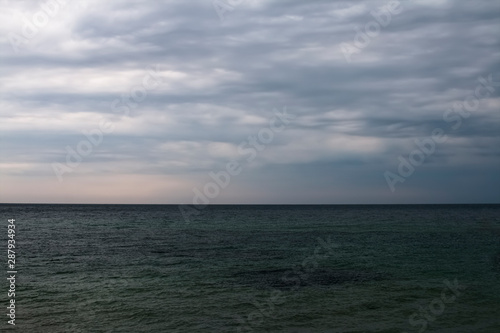 Marine background, skyline, cloudy sky over the sea.