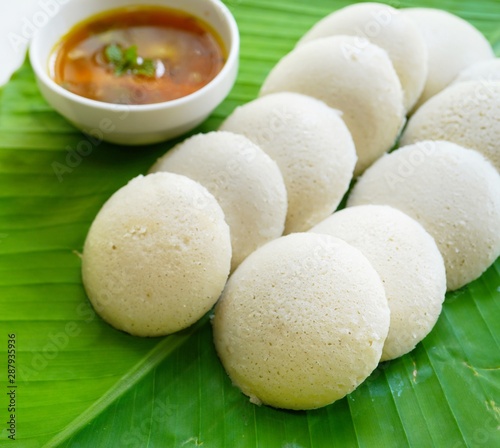 Idlis /Steamed rice cakes - South Indian breakfast served in banana leaf, selective focus