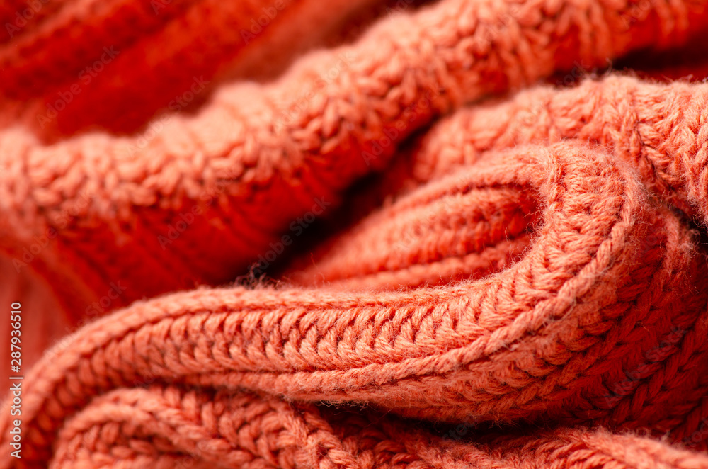 Orange warm knited material fabric sweater texture blur background Orange warm knited material fabric sweater texture blur background