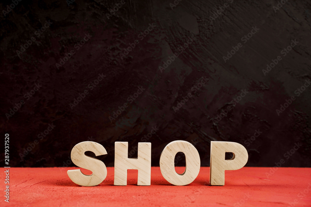 Front view of shop word on red table Front view of shop word on red table