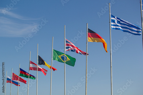 Flags of the world countries blowing in the wind on a background of the sky