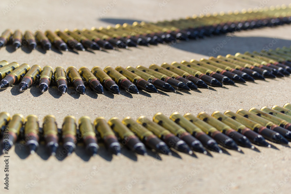 A row of ammunition cartridges - three rows of bullets in the circle