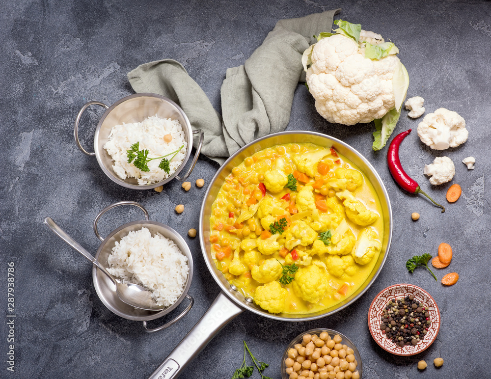 Vegetarian curry with cauliflower and chickpeas, healthy homemade vegan food, indian cuisine, clean eating concept - obrazy, fototapety, plakaty 