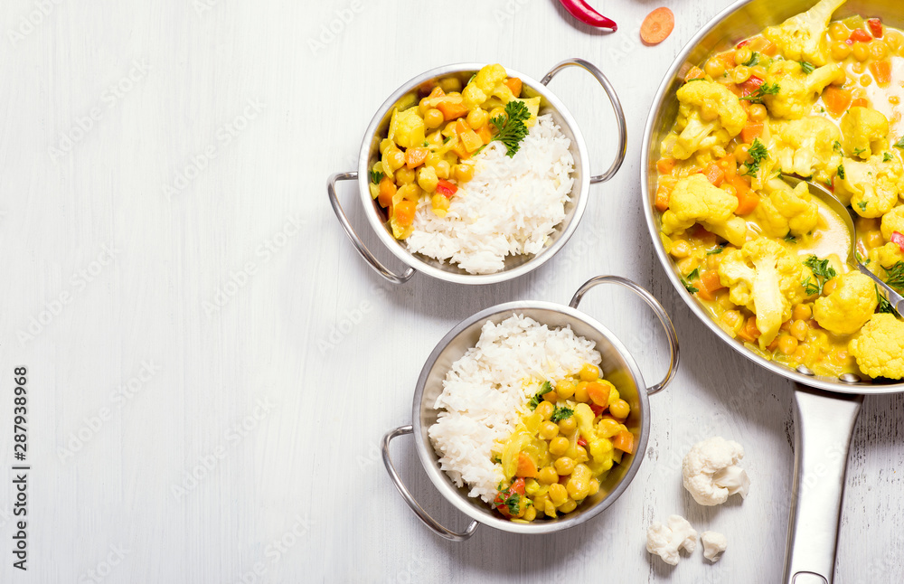 Vegetarian curry with cauliflower and chickpeas, healthy homemade vegan food, indian cuisine, clean eating concept, food copy space background Vegetarian curry with cauliflower and chickpeas, healthy homemade vegan food, indian cuisine, clean eating concept, food copy space background