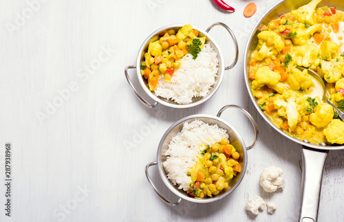 Vegetarian curry with cauliflower and chickpeas, healthy homemade vegan food, indian cuisine, clean eating concept, food copy space background