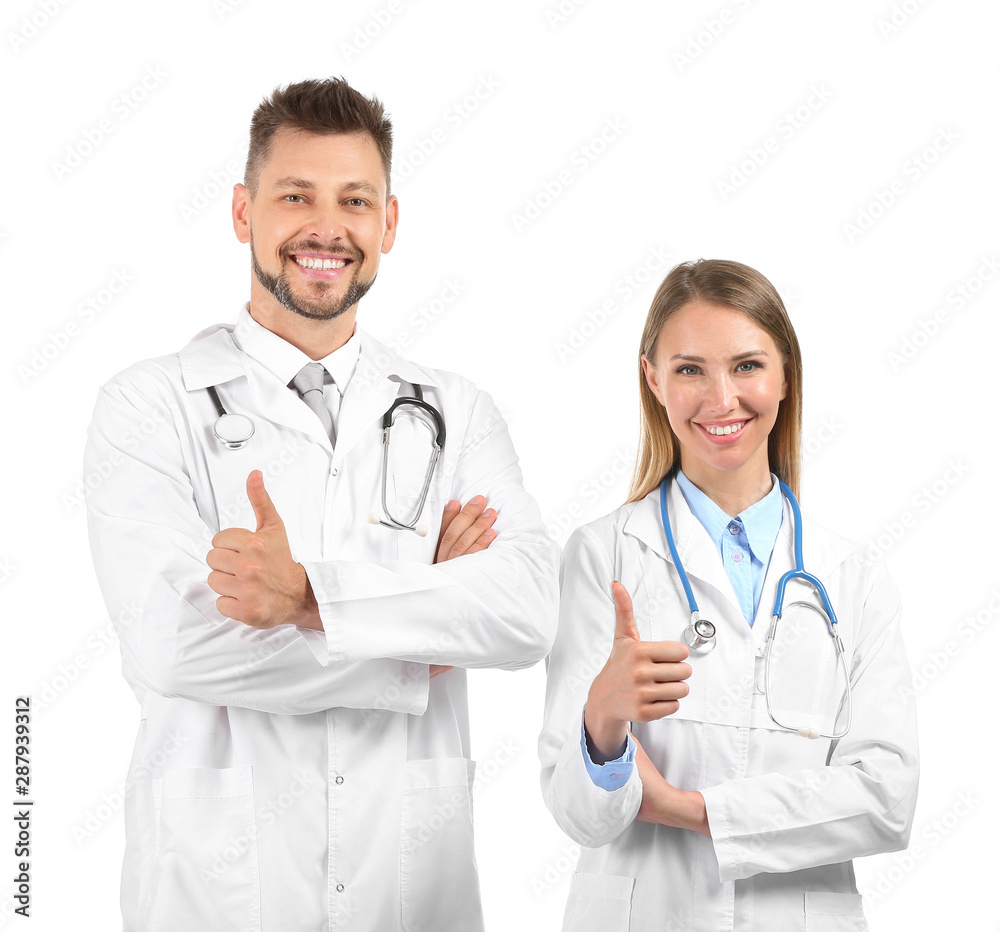 Male and female doctors showing thumb-up on white background Male and female doctors showing thumb-up on white background