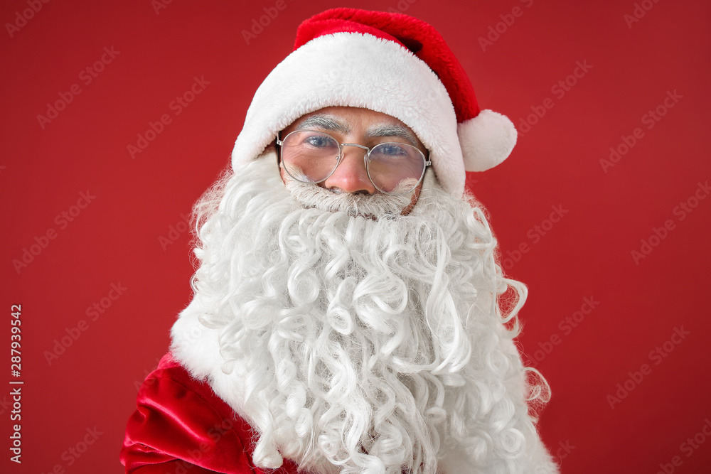 Portrait of Santa Claus taking selfie on color background