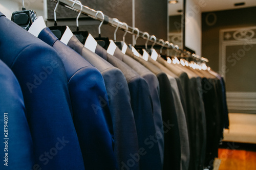 Картината върху платно Men suit jackets on hanger in a shop