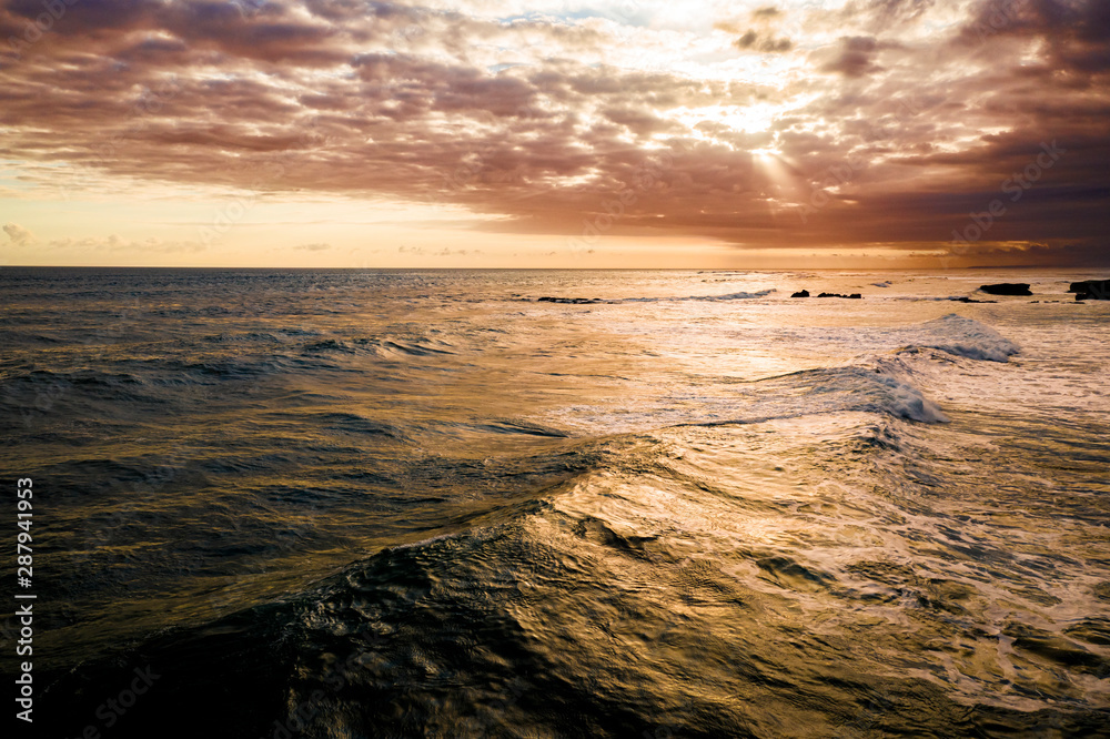 Dramatic sunset over a tropical ocean aerial, Bali, Indonesia