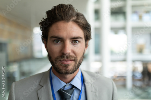 Caucasian businessman looking at camera in modern office