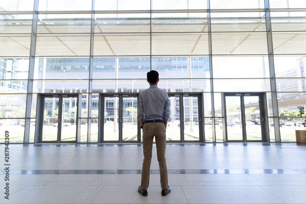 asian male executive standing in modern office asian male executive standing in modern office