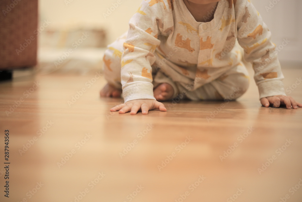 baby hand planted firmly on the grossly light tone wooden floor. child development and growing up concepts. early education and parenting Theme. baby hand planted firmly on the grossly light tone wooden floor. child development and growing up concepts. early education and parenting Theme.