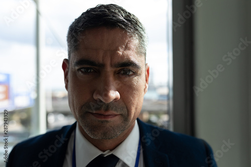 Close-up of businessman face looking at camera in office