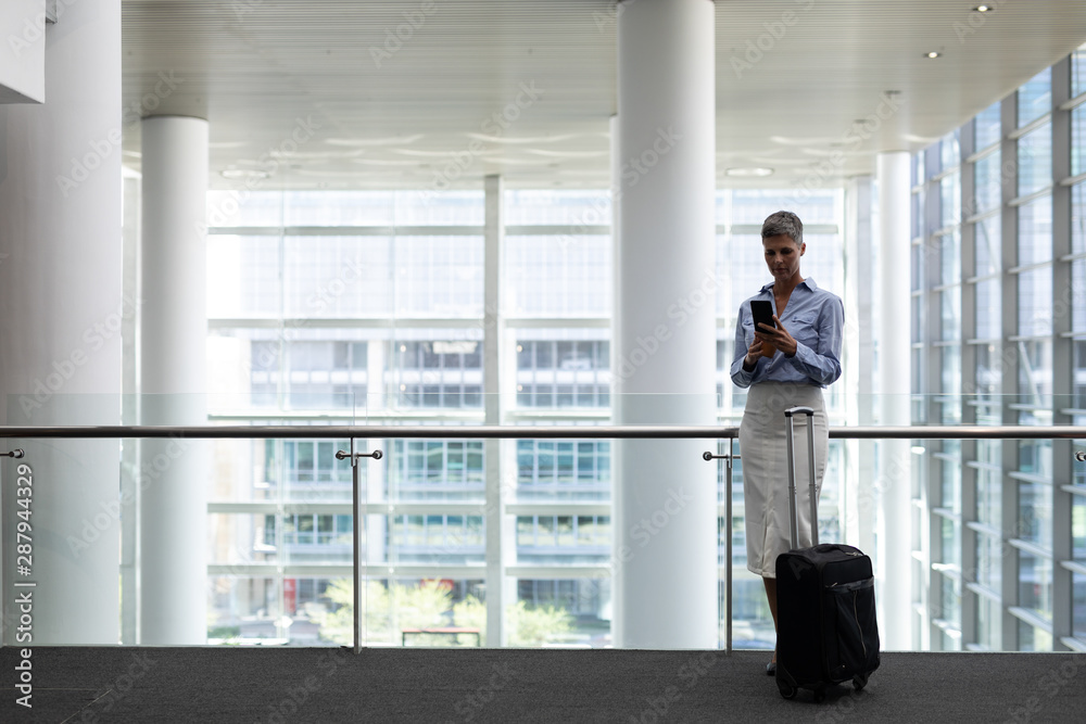 Caucasian businesswoman using mobile phone in office Caucasian businesswoman using mobile phone in office