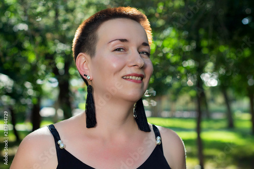 Close-up portrait of a beautiful short-haired woman in the park