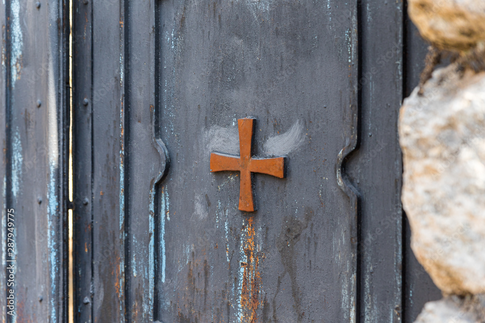 Metal gates decorated with a cross in the catholic Christian Transfiguration Church located on Mount Tavor near Nazareth in Israel