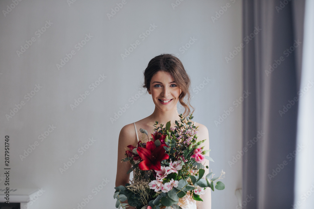 Portrait of beautiful tender young smiling woman holding bouquet. Portrait of beautiful tender young smiling woman holding bouquet.