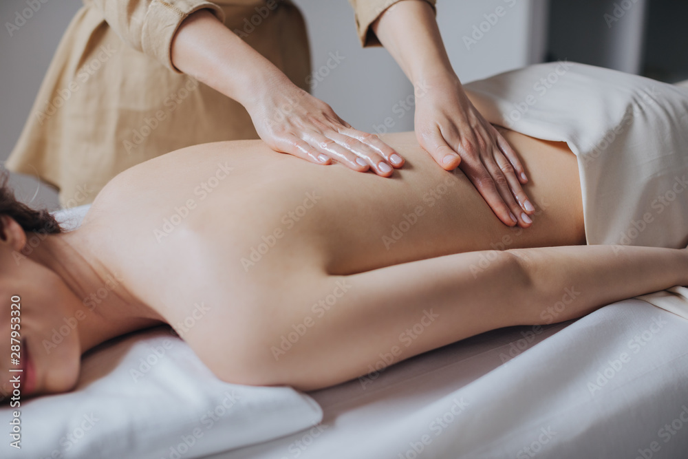 Hands of unrecognisable woman masseuse doing back massage. Hands of unrecognisable woman masseuse doing back massage.