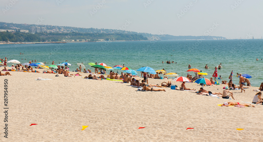 VARNA, BULGARIA - AUGUST 14, 2015: people rest on city beach. VARNA, BULGARIA - AUGUST 14, 2015: people rest on city beach.