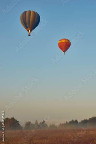 Two balloons soaring into the sky. © Konstiantyn Zapylaie